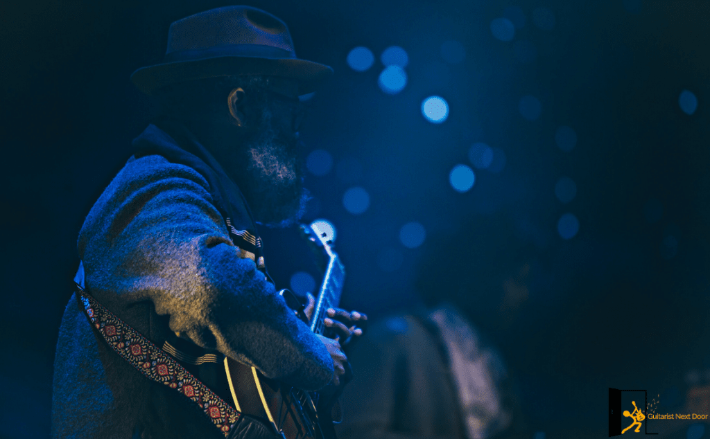 displays a guitar player playing the blues
