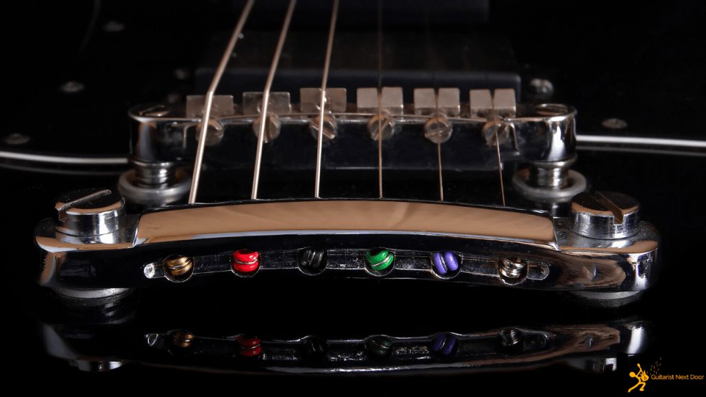 displays Tune O Matic guitar bridge that makes intonation adjustments easy